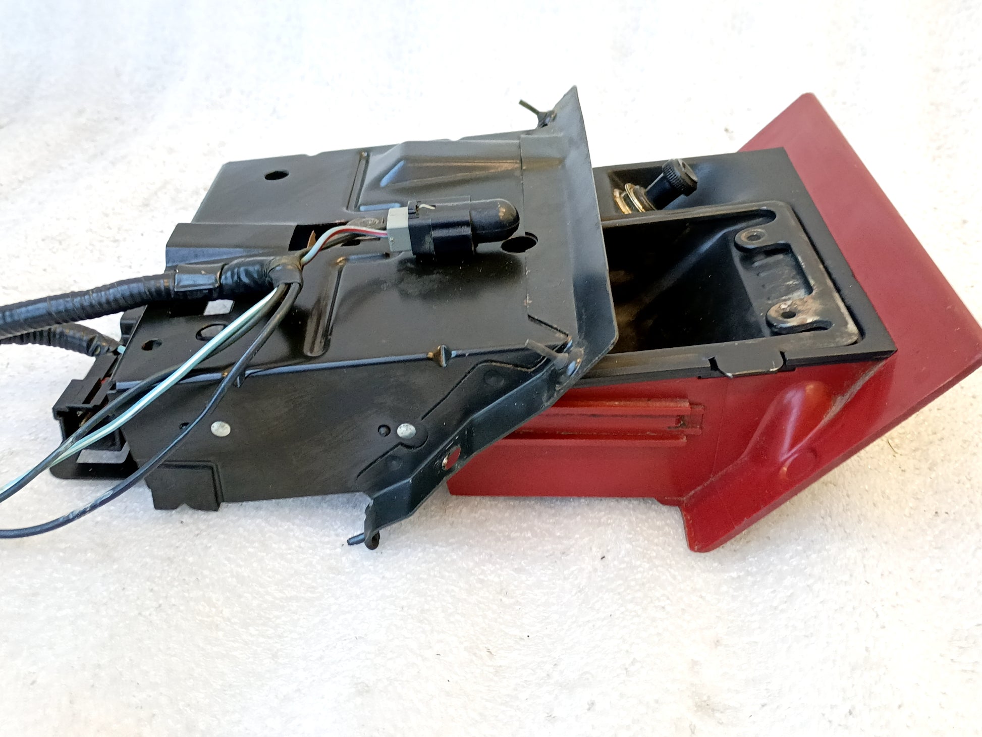 Refurbished ashtray assembly for 1992-1996 Ford F150, F250, F350, Bronco, with red finish, mounting bracket, and wire harness.