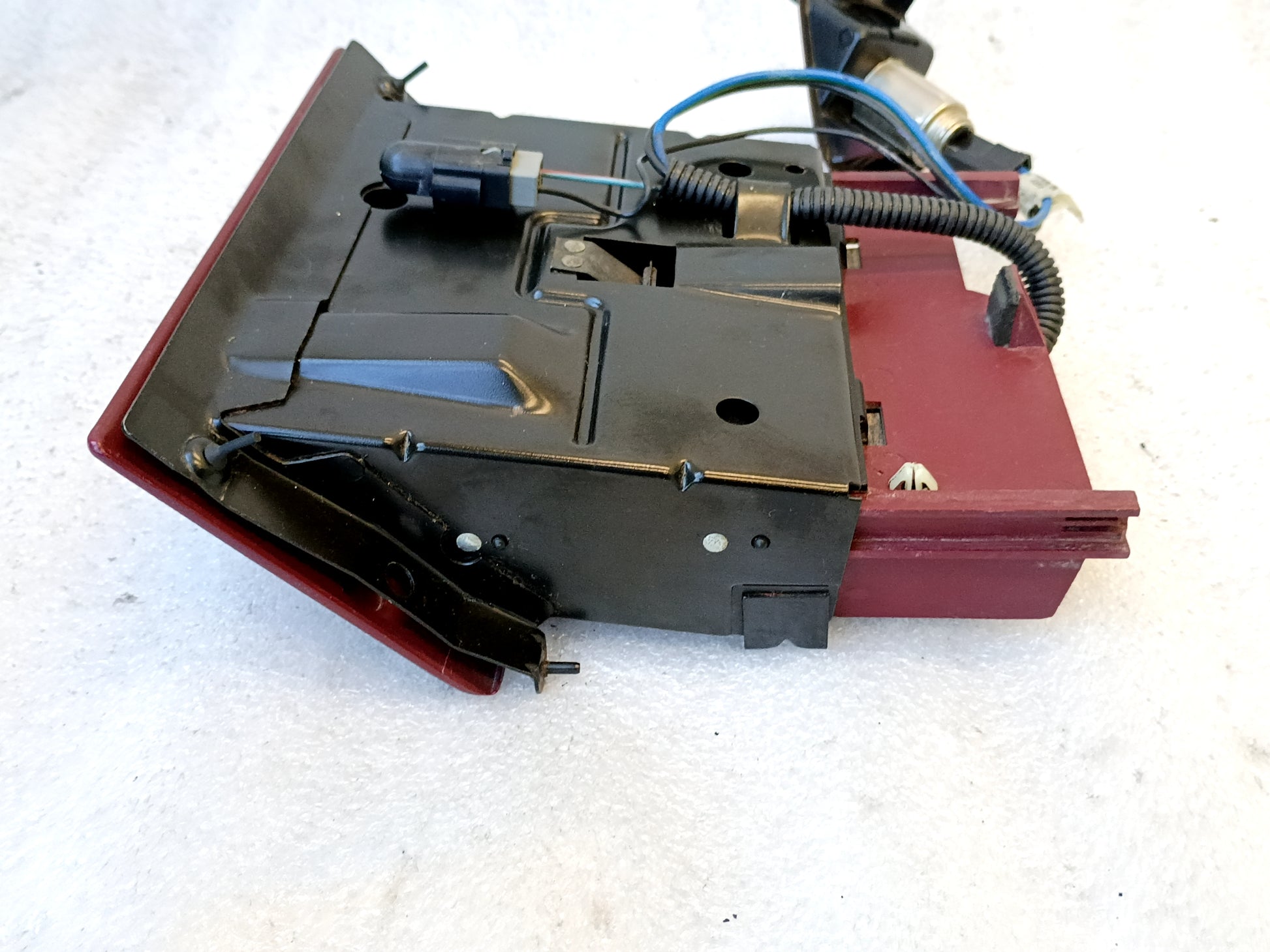 Refurbished dark ruby red ashtray assembly for 1992-1996 Ford trucks, with mounting bracket and rewired harness.