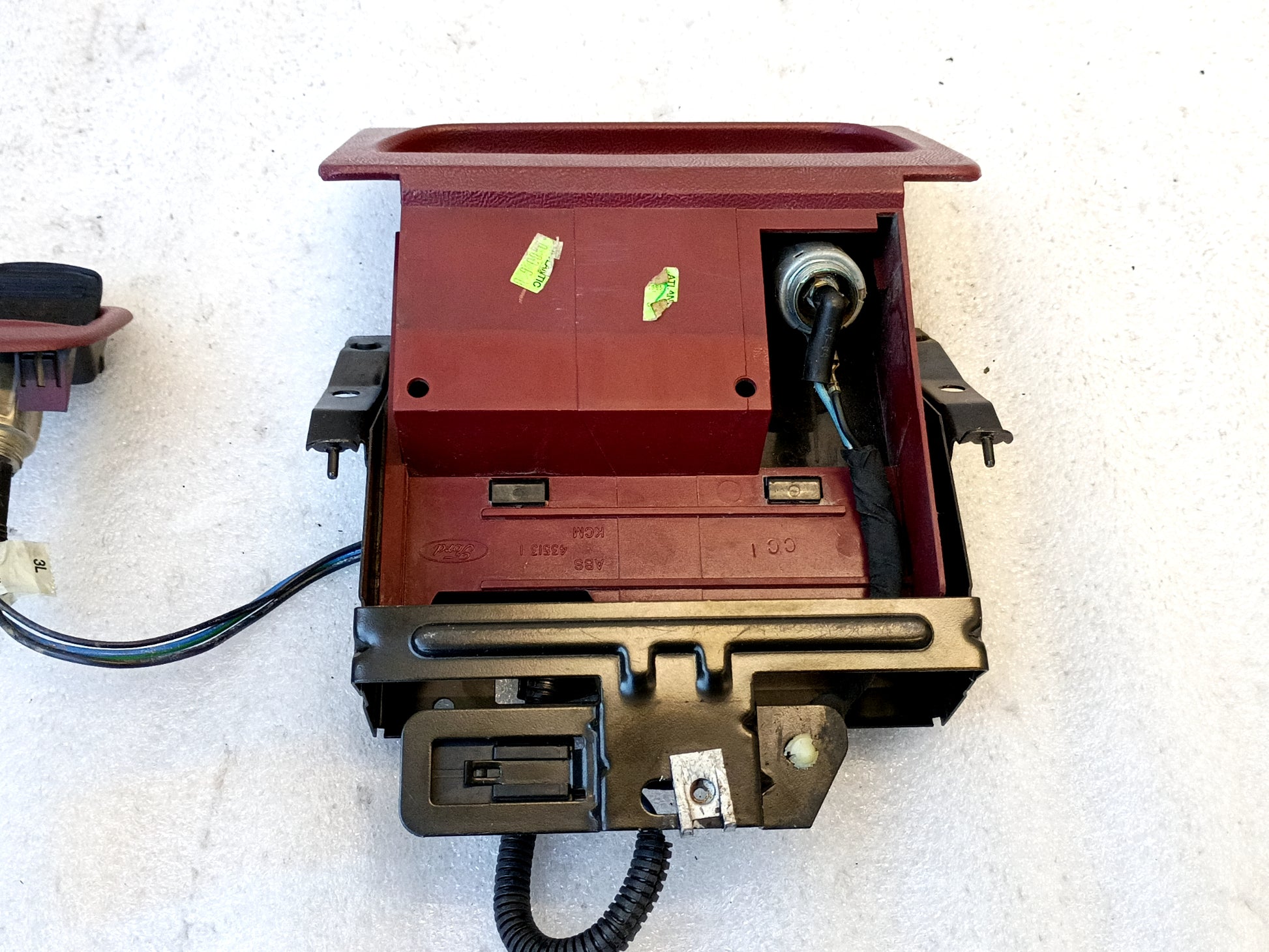 Refurbished dark ruby red ashtray assembly with mounting bracket, power port, and wire harness for 1992-1996 Ford trucks.