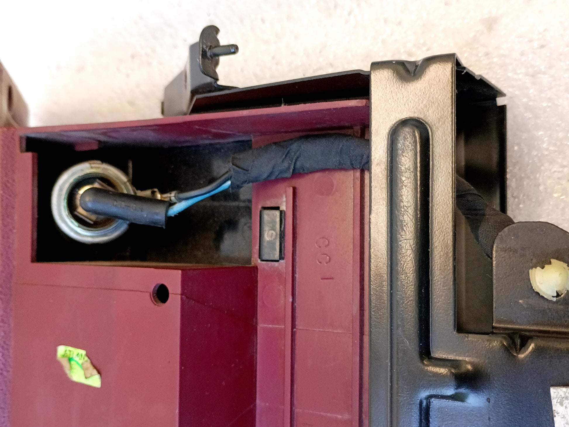 Refurbished dark/ruby red ashtray assembly with power port, mounting bracket, and wire harness for 1992-1996 Ford trucks.