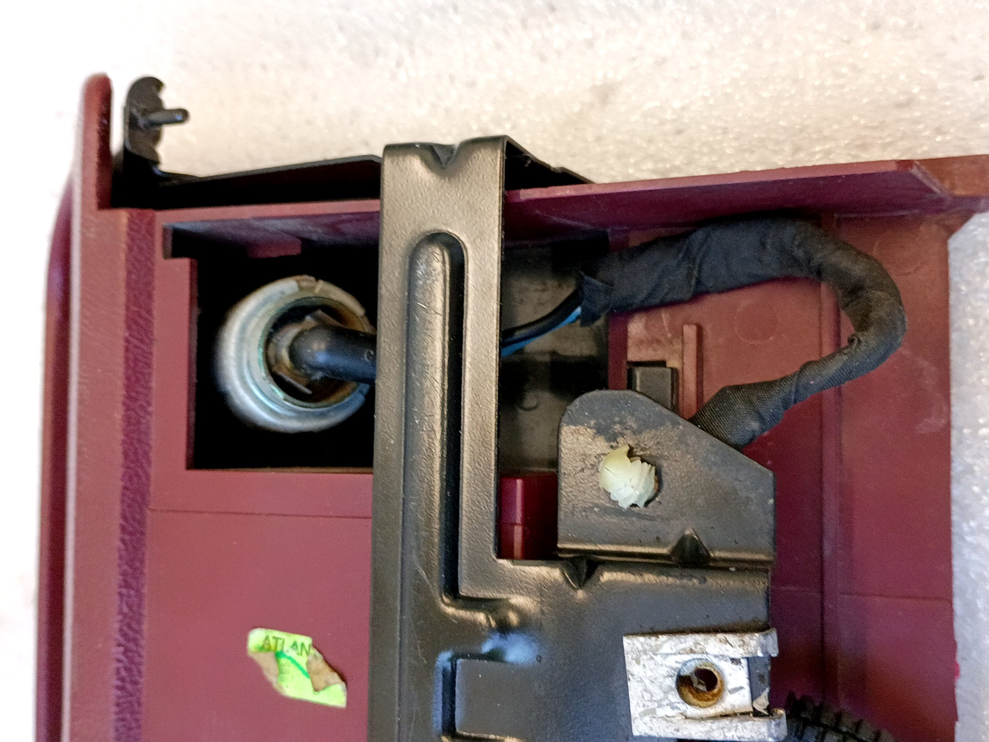 Refurbished dark/ruby red ashtray assembly for 92-96 Ford F150/F250/F350/Bronco with mounting bracket and power port.