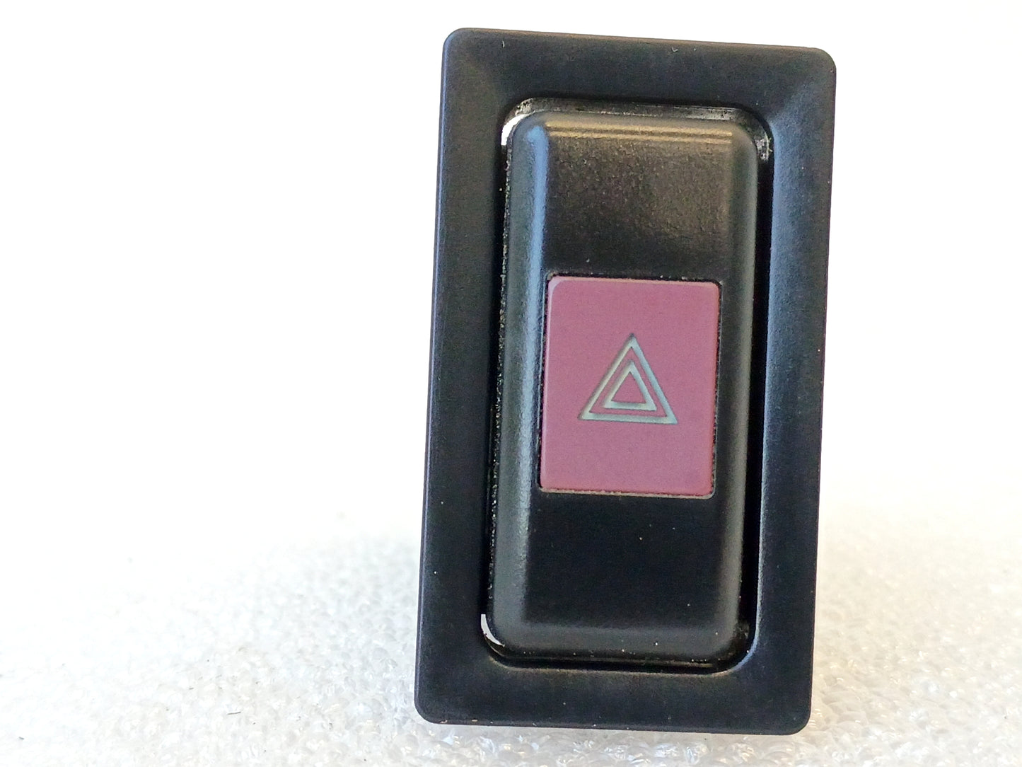 OEM Toyota hazard flasher light switch for 1989-1995 Truck/4Runner, black with red triangle button, part 84332-89110.
