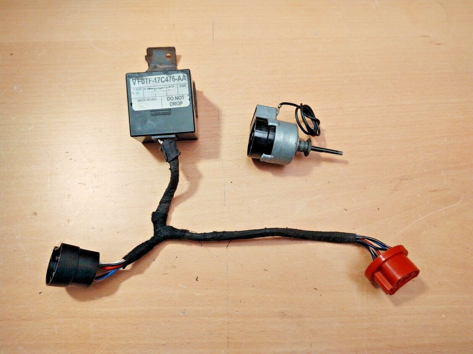 OEM Ford intermittent delay wiper switch assembly including the black Motorcraft delay module, cylindrical switch with shaft, and wire harness with red and black connectors for 1980-1991 F-Series trucks and Broncos.