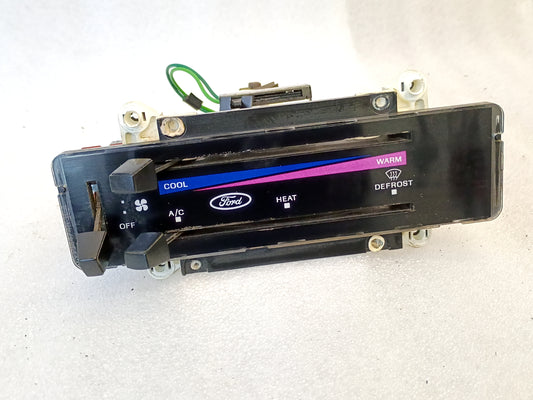 Ford OEM heater and AC control panel for 1980-1986 F-series and Bronco, featuring temp sliders and colored indicators.