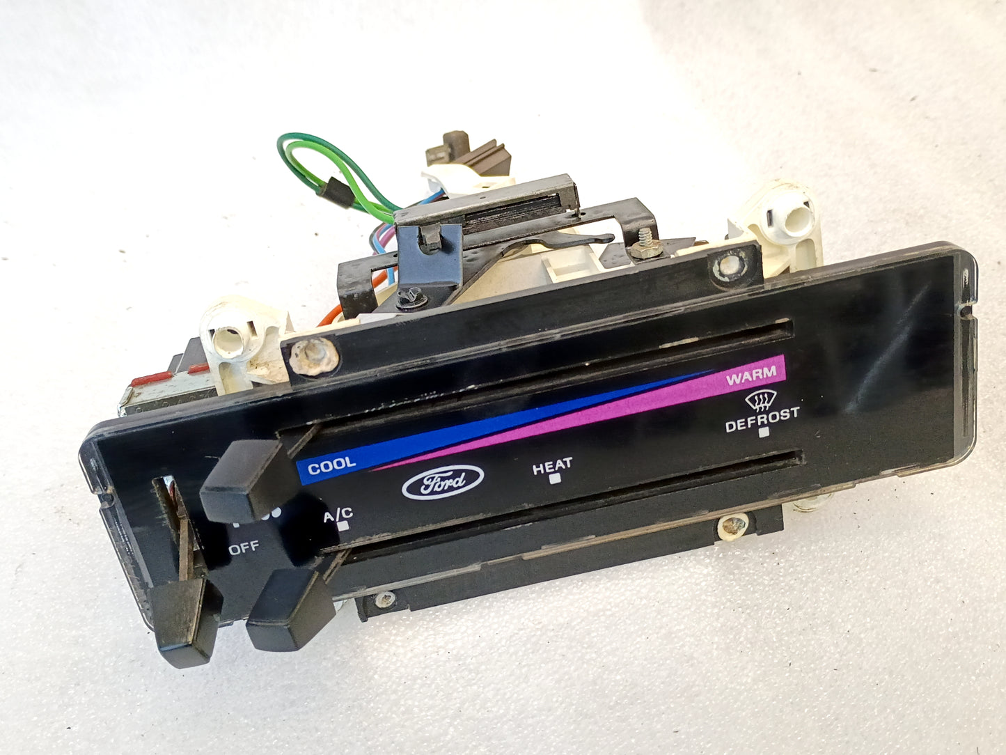 Ford heater and AC control panel for 1980-1986 F-Series and Bronco, featuring cool to warm slider and defrost options.