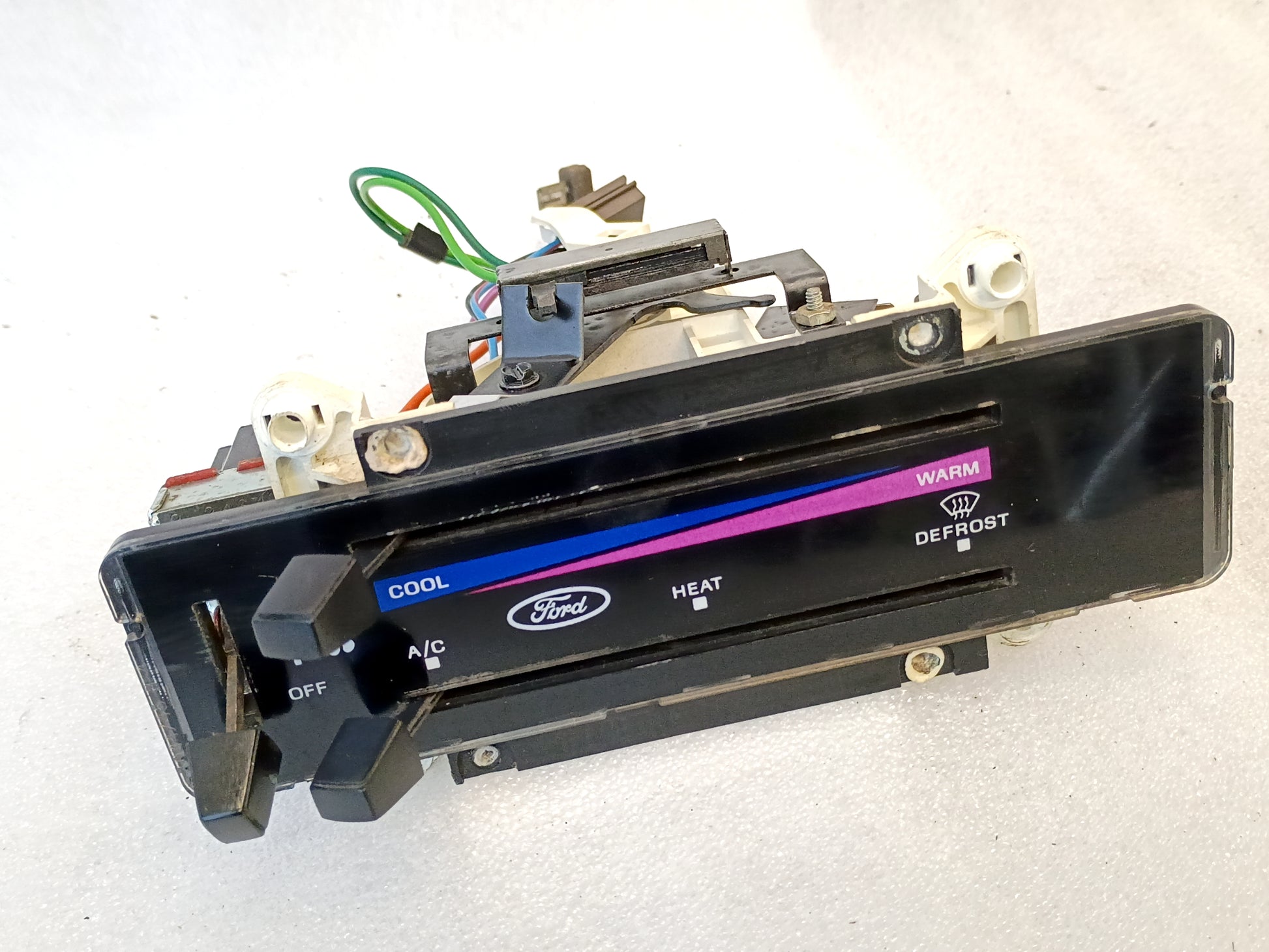 Ford heater and AC control panel for 1980-1986 F-Series and Bronco, featuring cool to warm slider and defrost options.
