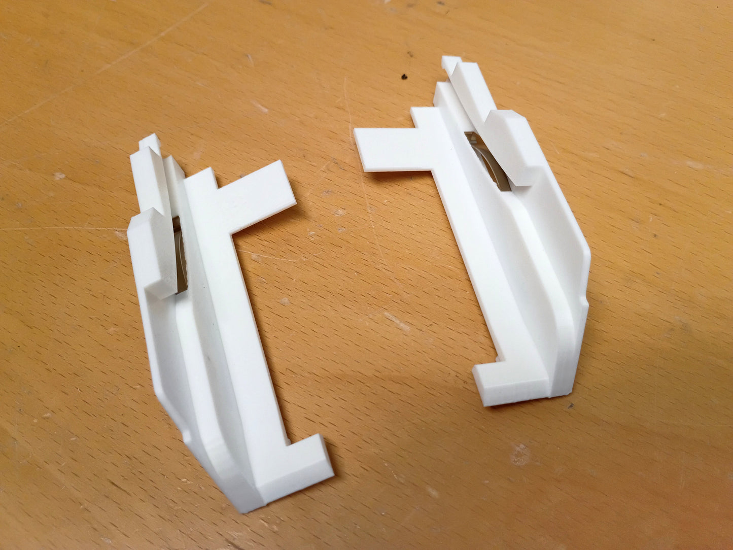 White plastic ashtray guides compatible with 1989-2004 Toyota models, on a wooden surface.