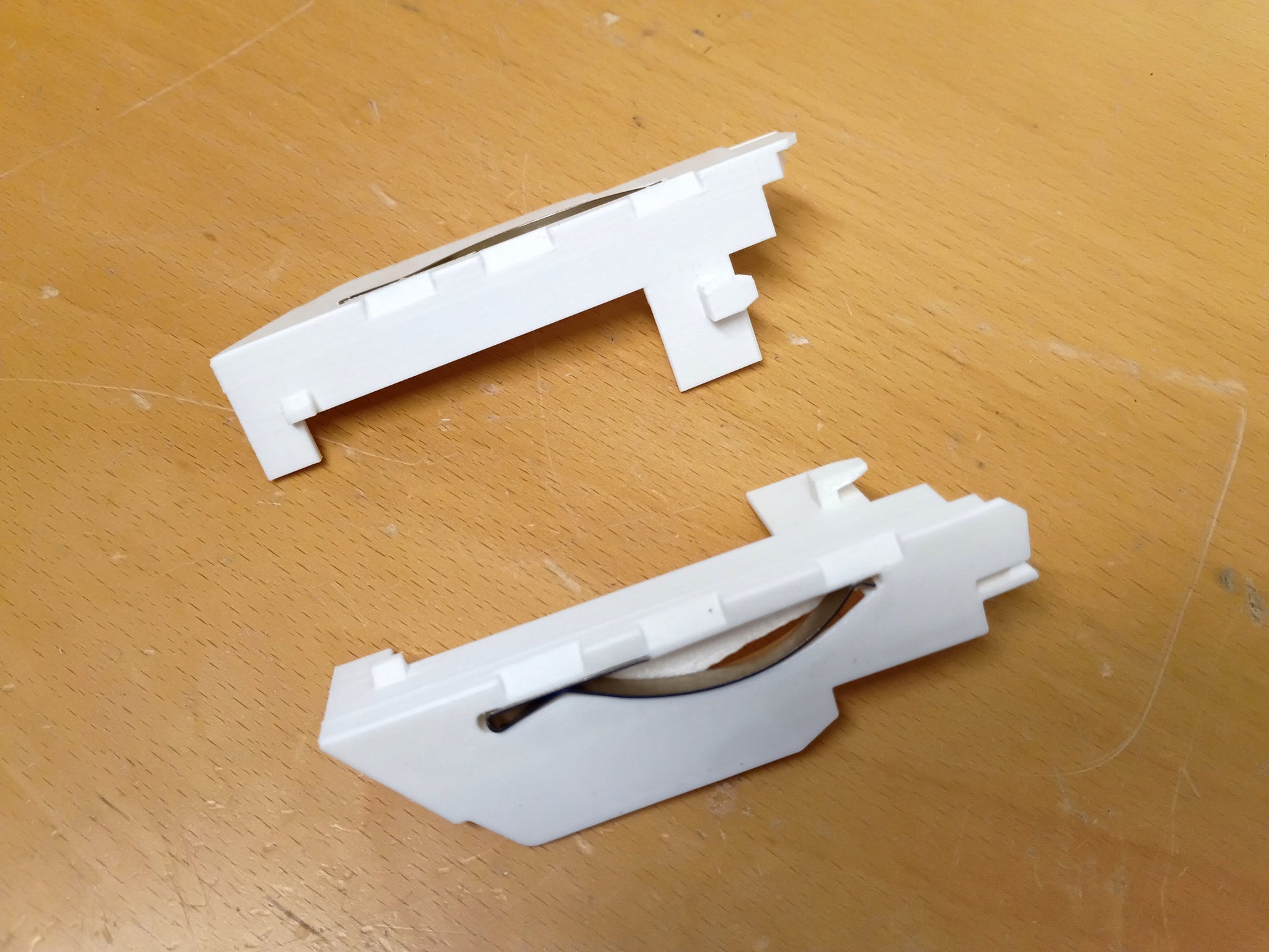 Reproduction ashtray guides for 1989-2004 Toyota vehicles, shown in white plastic, by Blue Truck Parts.