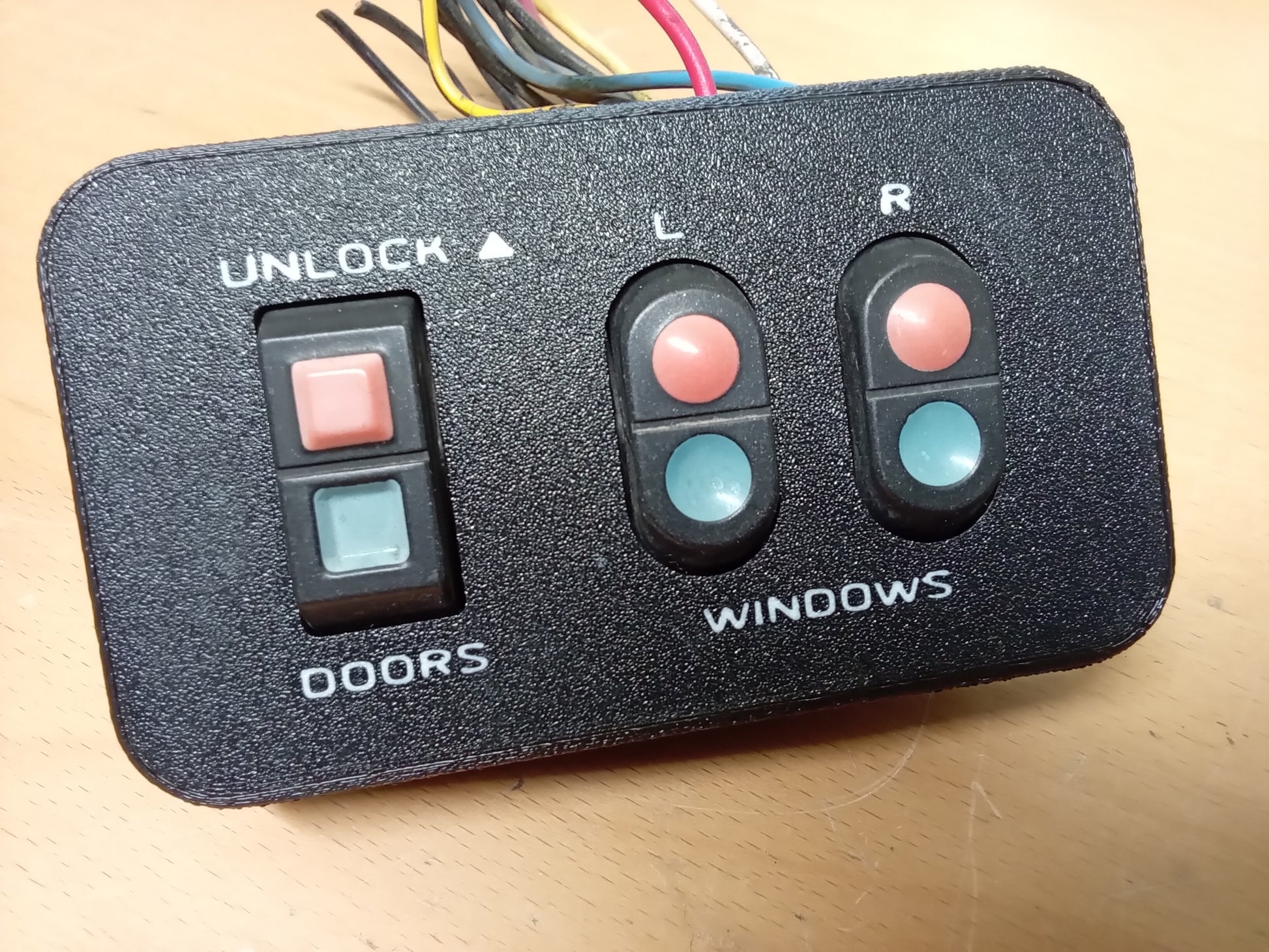 Ford power window and door lock bezel with labeled buttons for unlock, doors, and windows; wires attached, designed for 87-91 F-Series/Bronco.