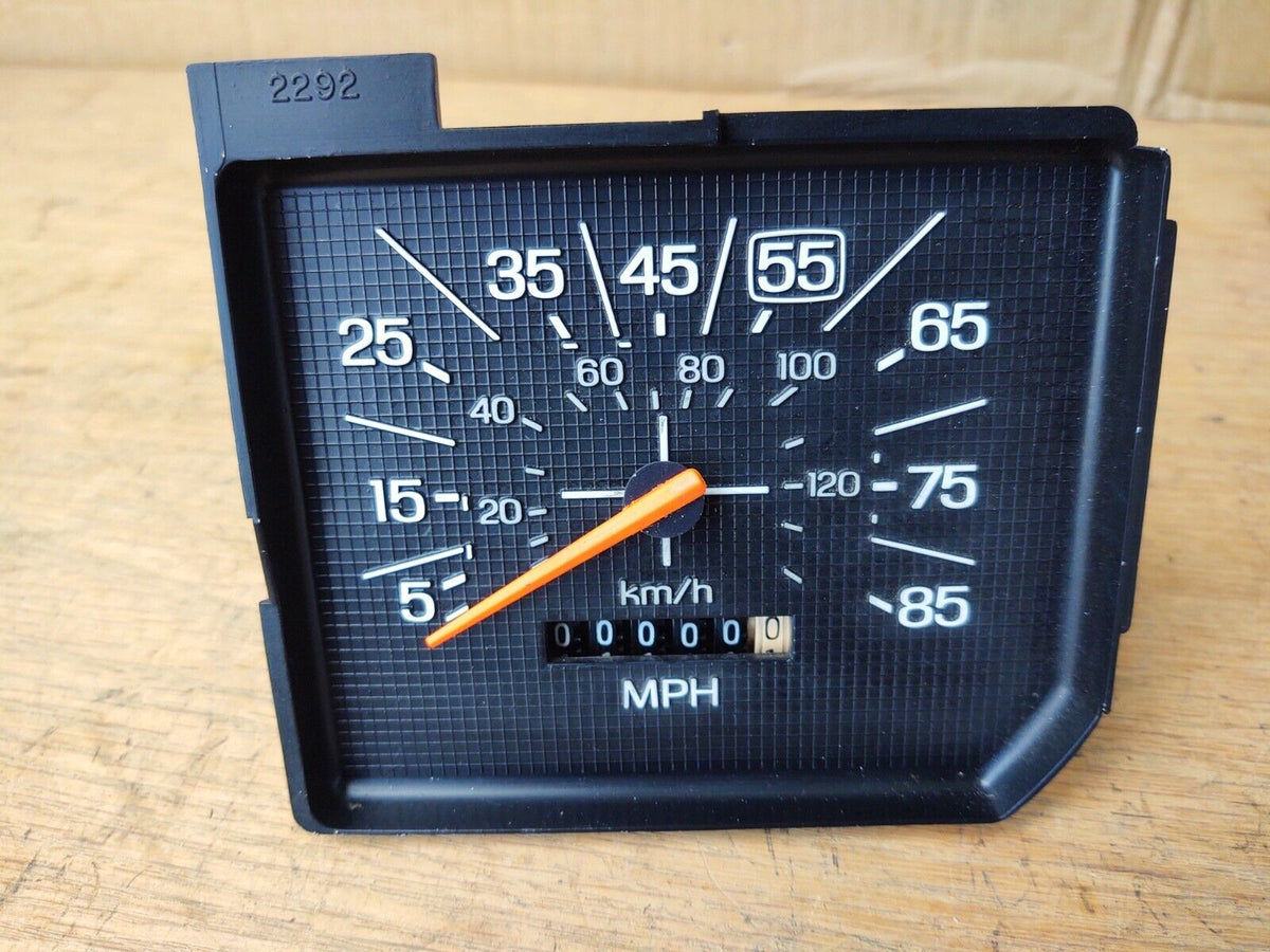 OEM Ford 1980-1986 speedometer gauge for F150, F250, F350, and Bronco. Features a black textured face with white numbers up to 85 MPH, an orange indicator needle, and an odometer showing 000000 miles.