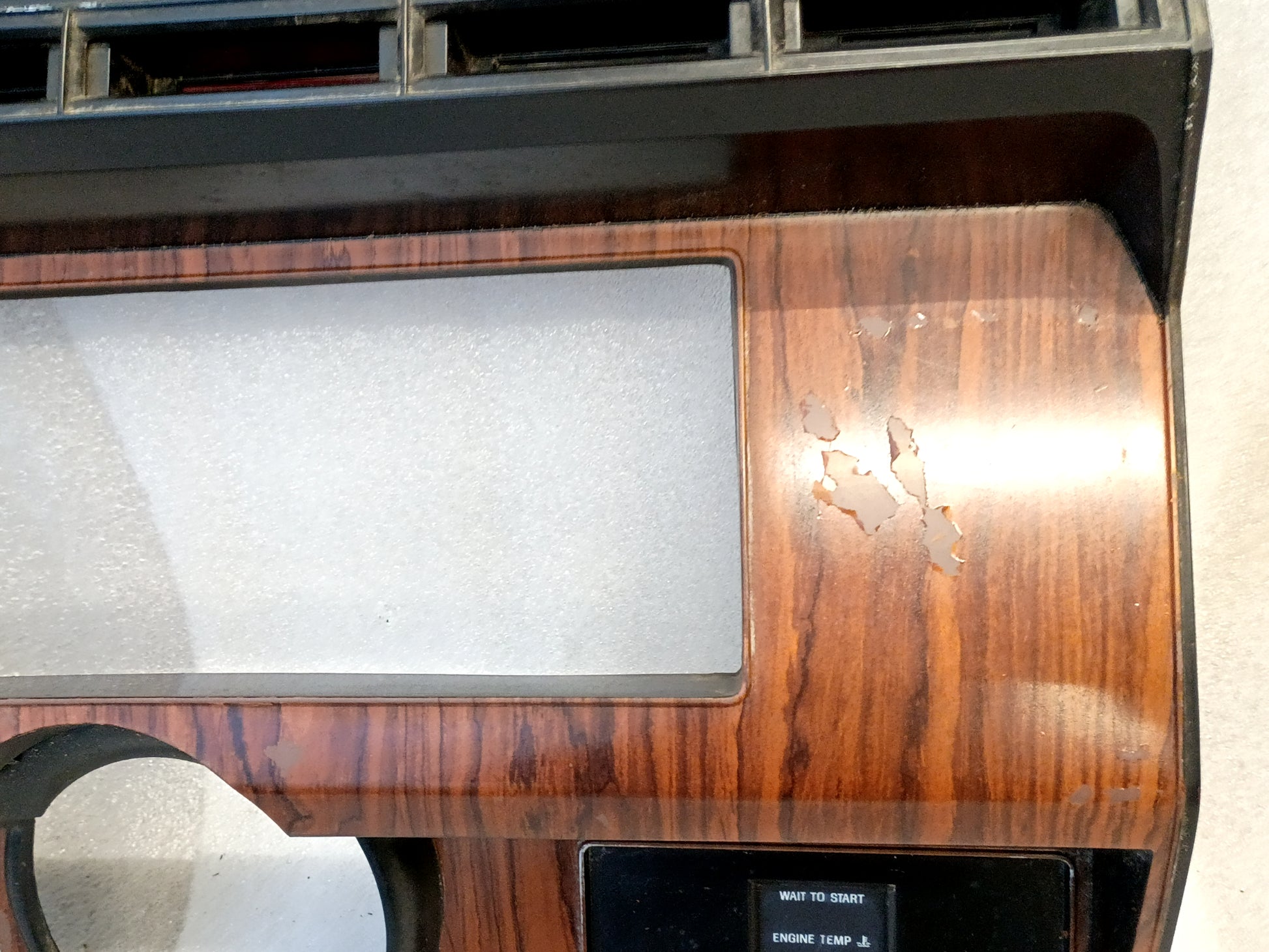 Ford F250/F350 gauge cluster bezel with Rose Wood pattern and diesel indicator lights, part number EOTB-10445C90-B, showing wear.