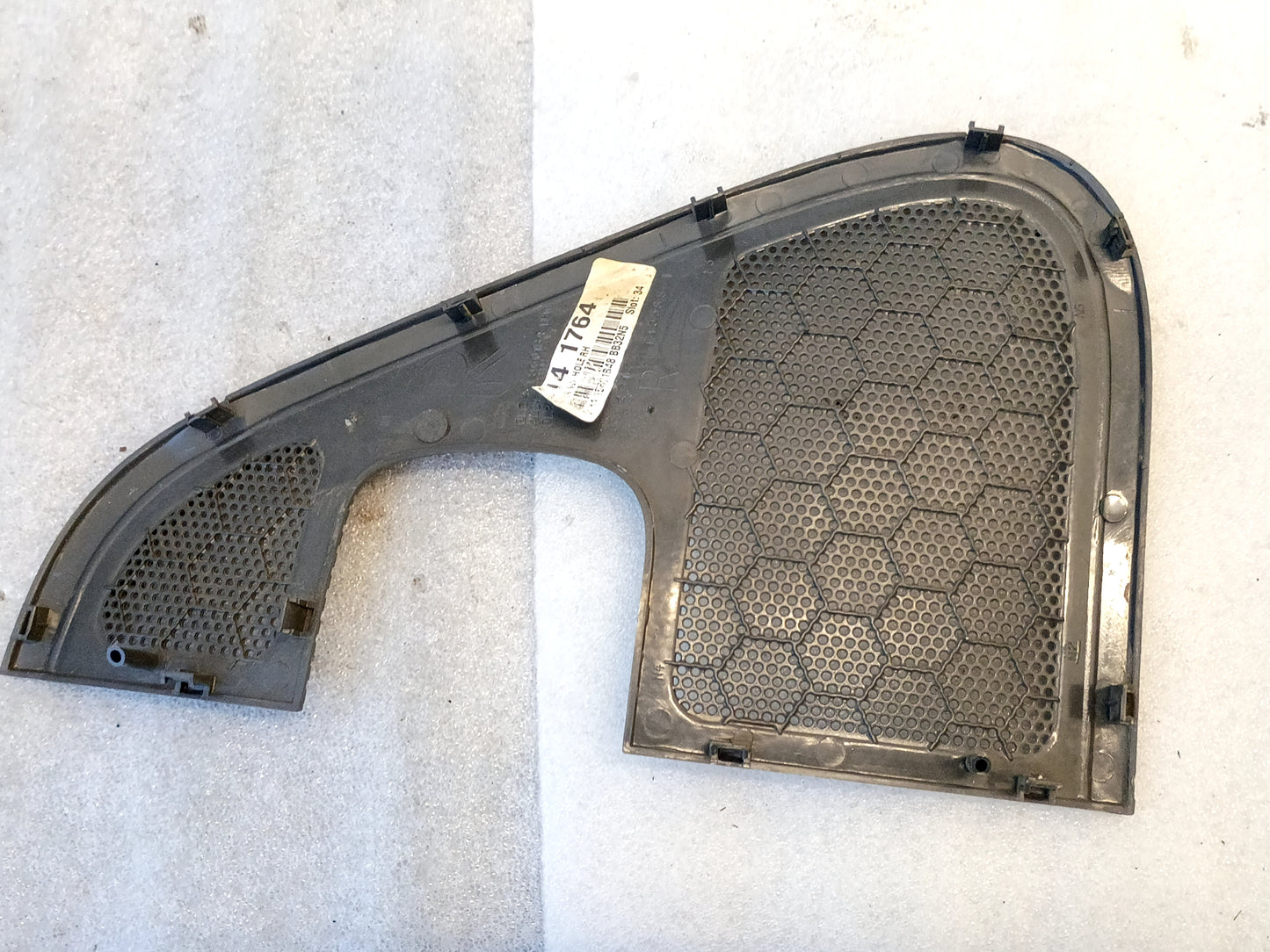 Dark gray speaker grill cover for 2004-2008 Ford F-150 door panel, featuring a hexagonal pattern, left side.