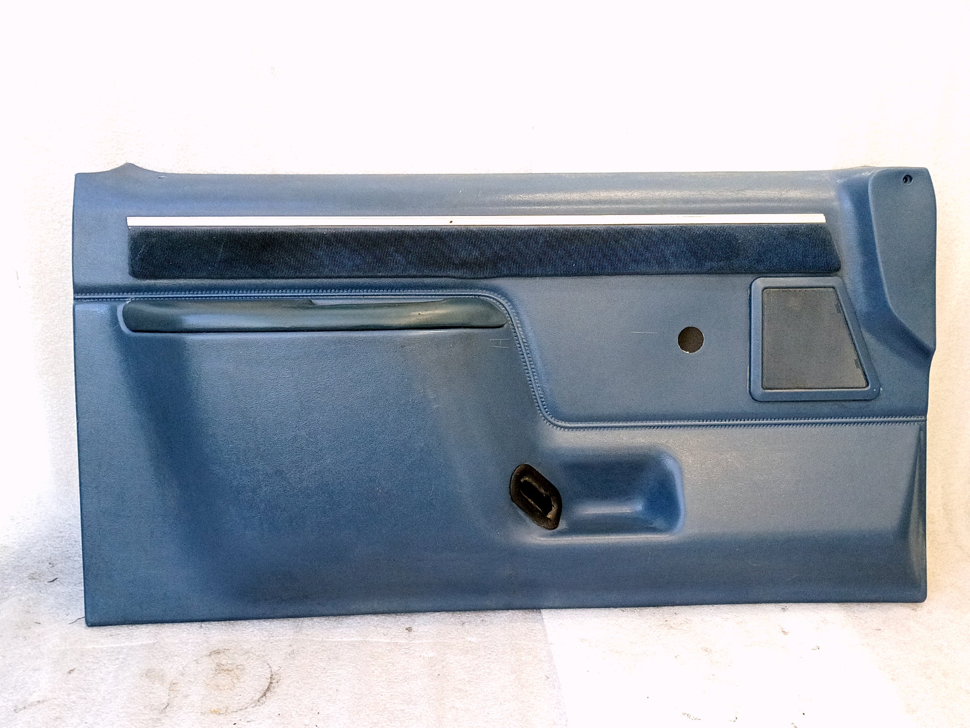 Light blue door panel with fabric strip, suitable for 1987-1991 Ford F-Series and Bronco. Includes map pocket and speaker grill.