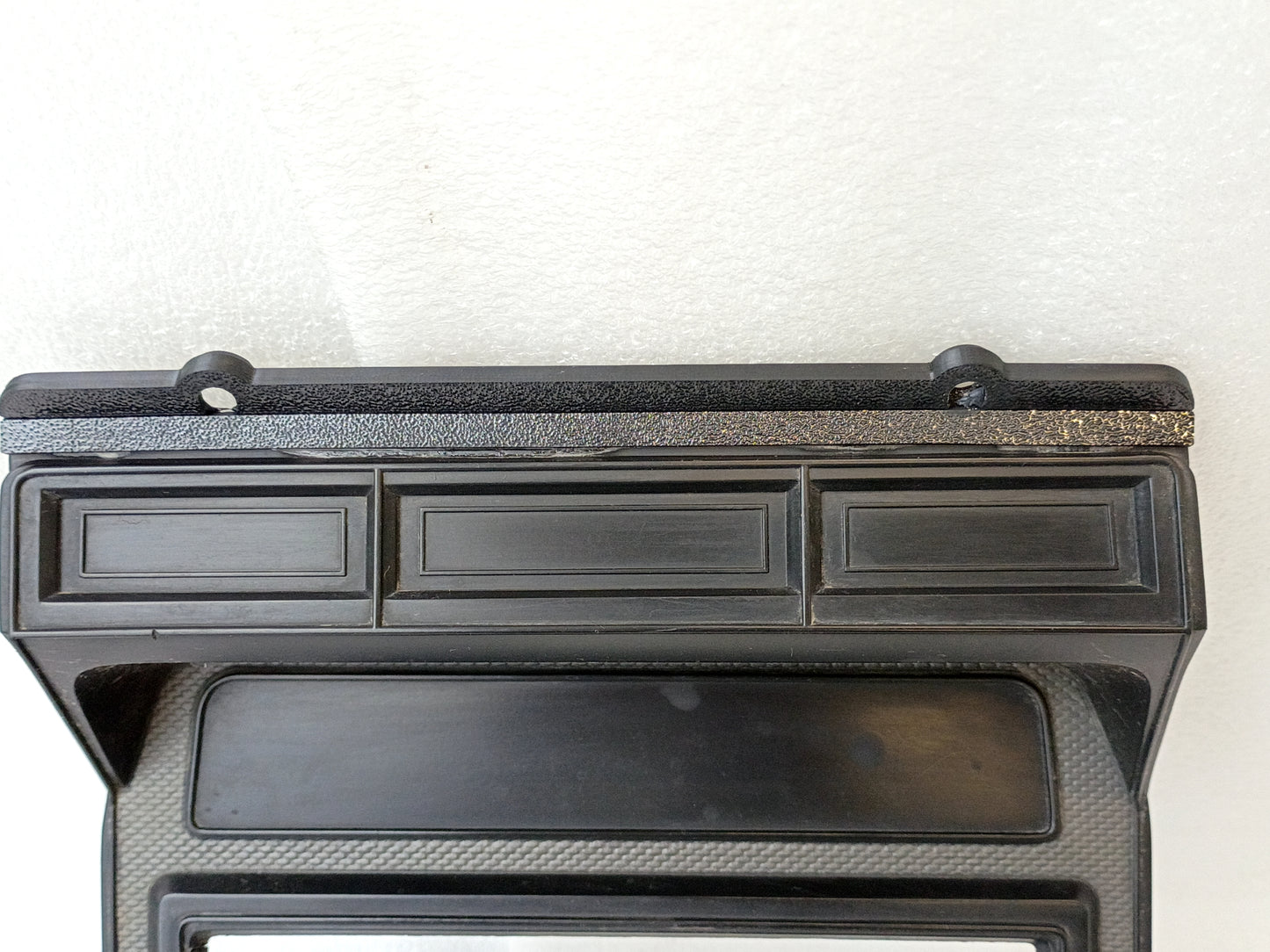 Silver radio and heater bezel for Ford trucks, featuring a single DIN radio hole. Compatible with 1980-1986 models.