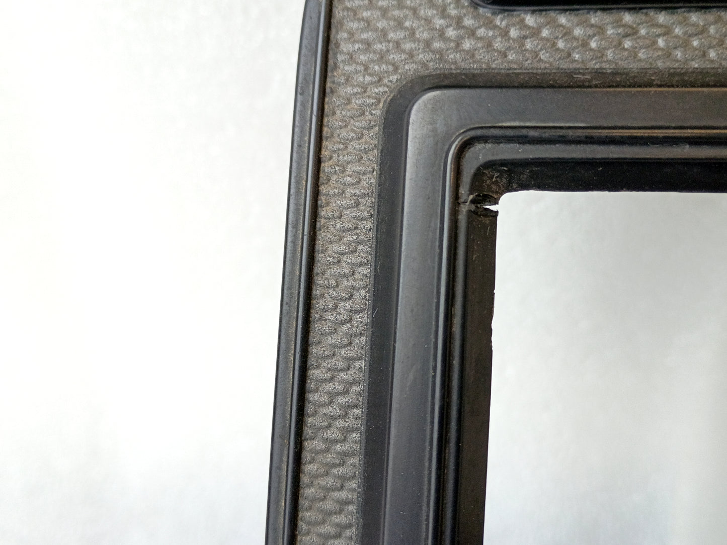 Textured silver radio and heater bezel for 1980-1986 Ford vehicles, featuring a single DIN radio hole.
