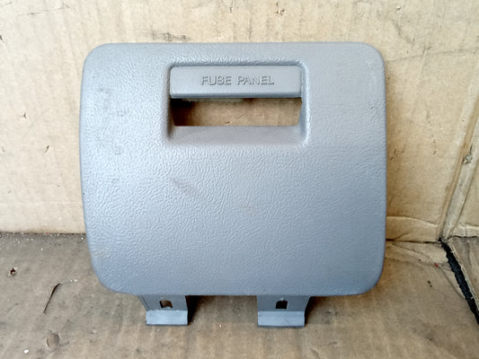 Light gray fuse panel cover for 1992-1996 Ford F150, F250, F350, and Bronco, with mounting clips, labeled "Fuse Panel".