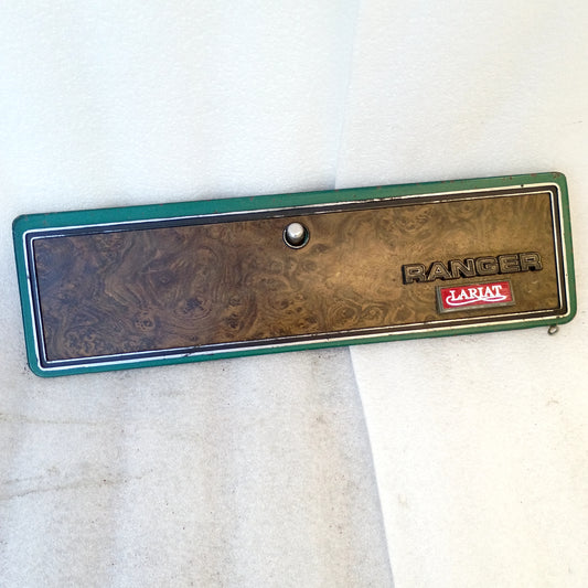 Green and woodgrain Ford Ranger Lariat glove box door with emblem, push button latch, compatible with 1973-1979 F-series trucks.