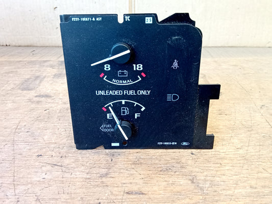 OEM Ford battery and fuel gauge cluster for 1992-1993 F-Series and Bronco. Black face with white text, featuring a battery voltage gauge, fuel gauge with Unleaded Fuel Only text, and seatbelt/headlight icons.