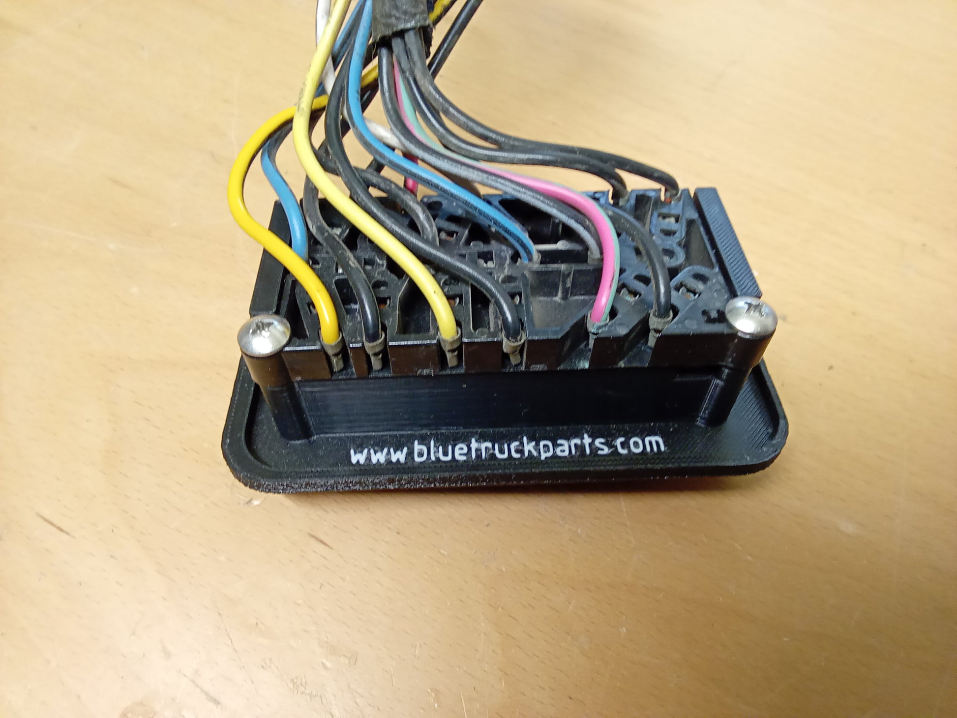 Ford power window and lock bezel for 87-91 F150, F350, Bronco; features color-coded wires and mounting screws.
