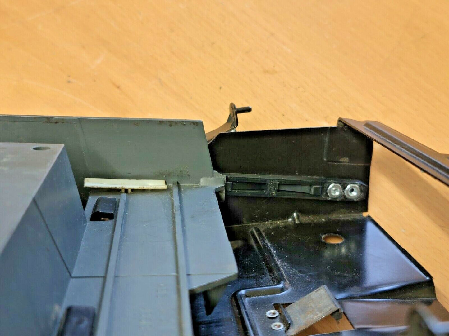 Close-up of the replacement ashtray guide set installed on a 1992-1997 Ford truck or Bronco bracket, showing the plastic guides secured with mounting screws.