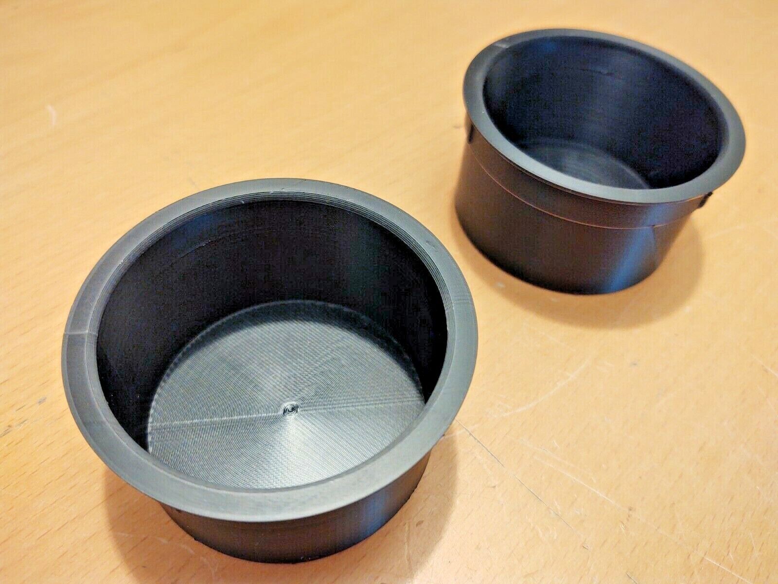 Pair of black polymer cup holder inserts designed for the center console of 1992-1996 Ford Bronco and F-Series trucks.