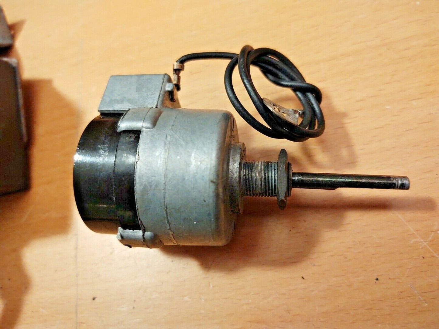 OEM Ford intermittent delay wiper switch with a cylindrical metal housing, a threaded mounting shaft, and an attached black coiled ground wire, designed for 1980-1991 Ford F-Series trucks and Broncos.