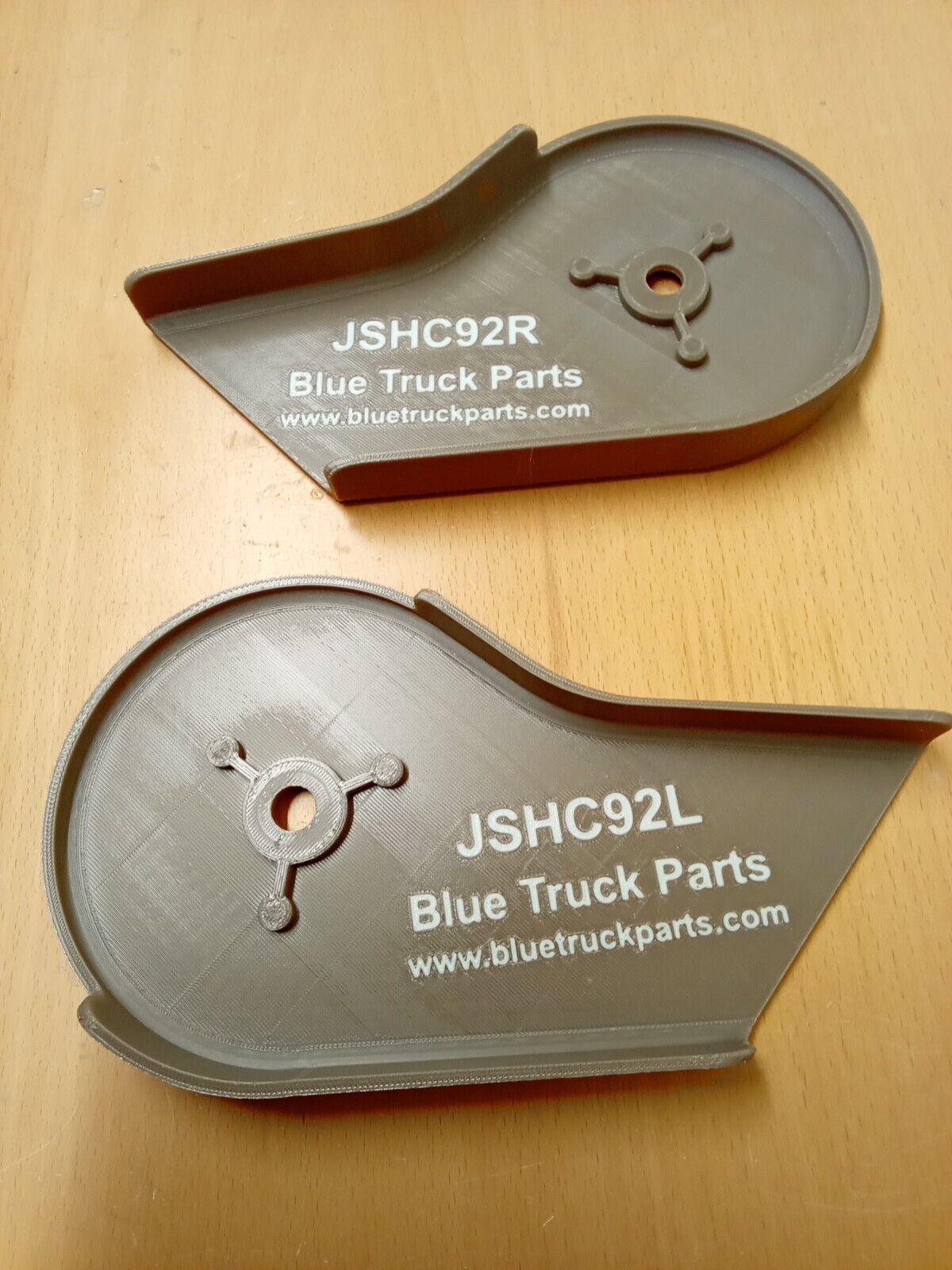 Pair of tan mocha split seat hinge covers labeled JSHC92R and JSHC92L from Blue Truck Parts, designed for 1992-1997 Ford F-150, F-250, and F-350 trucks.