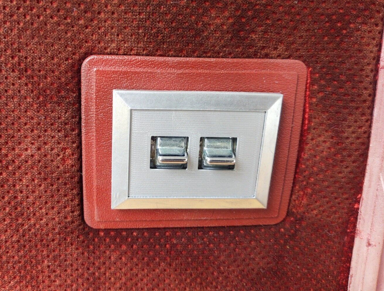 Red and silver dual power window switch bezel with two chrome switches, designed for 1980-1986 Ford F-150, F-250, F-350, and Bronco models.
