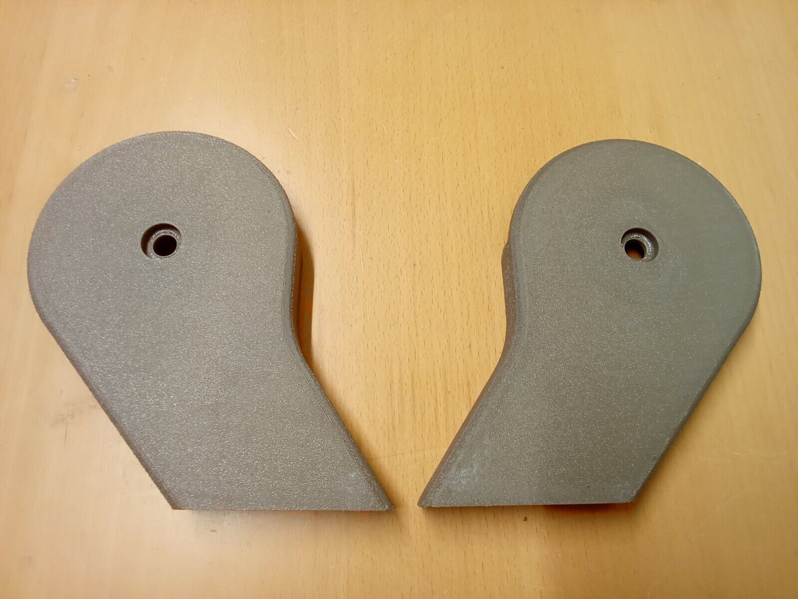 Pair of textured tan/mocha split seat hinge covers for 1992-1997 Ford F150, F250, and F350 OBS trucks. The plastic covers feature a teardrop shape with a central mounting screw hole.