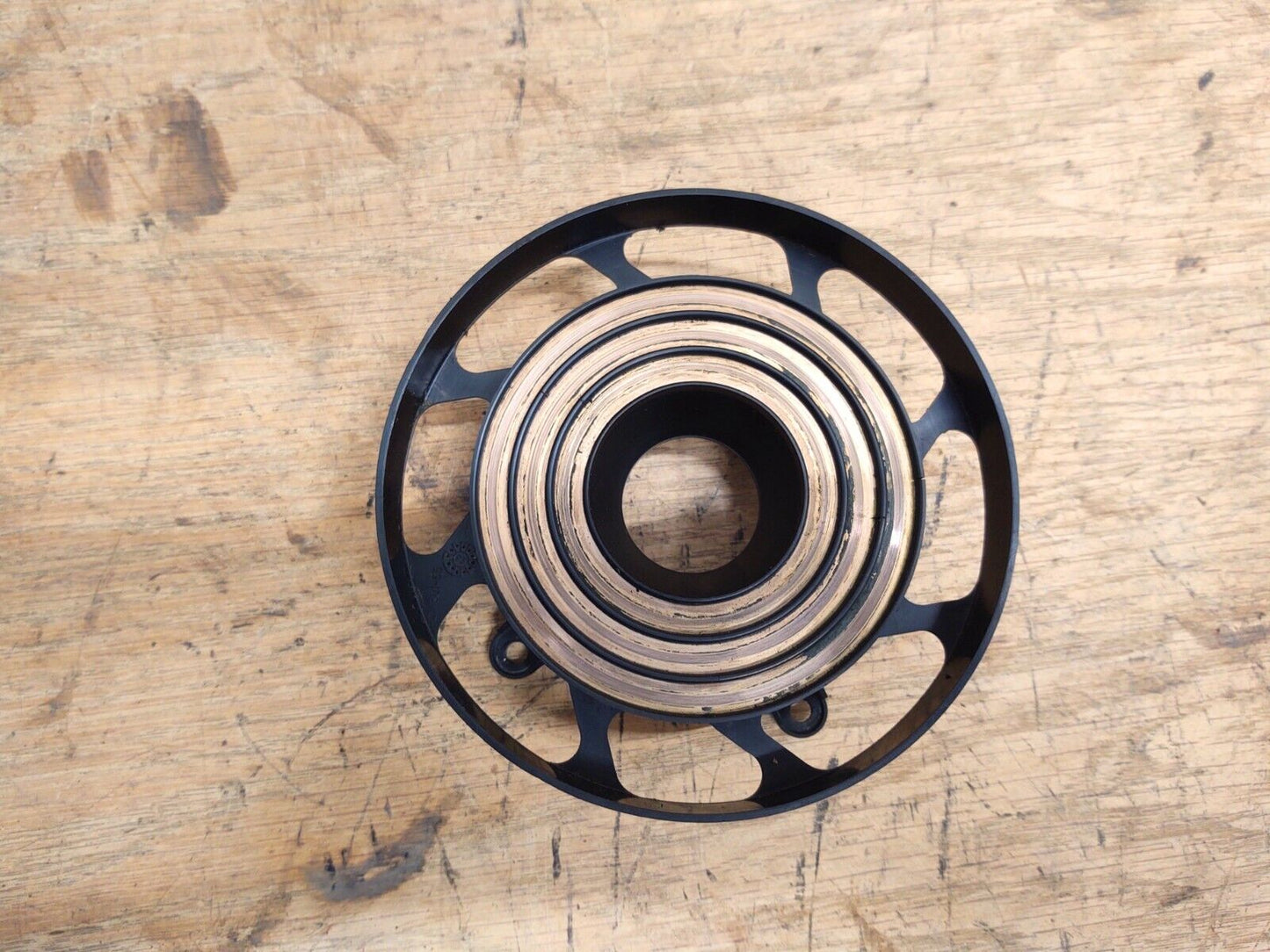 OEM Ford steering wheel clock spring slip ring for 1992-1996 F150, F250, and Bronco trucks without airbags, featuring circular concentric copper contact tracks.