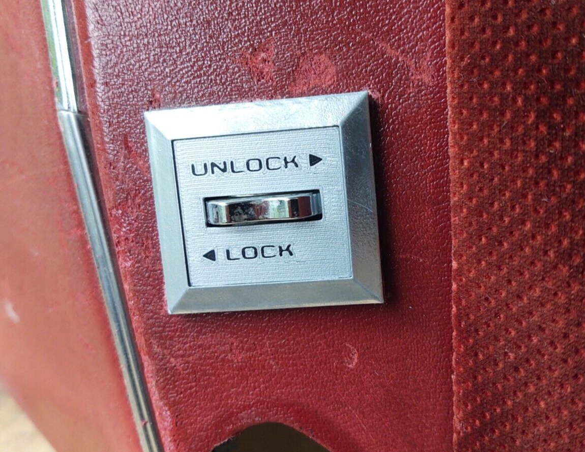 Silver power door lock switch bezel for a 1980-1986 Ford F-150, F-250, F-350, or Bronco, with a chrome rocker switch and black text reading UNLOCK and LOCK with directional arrows.