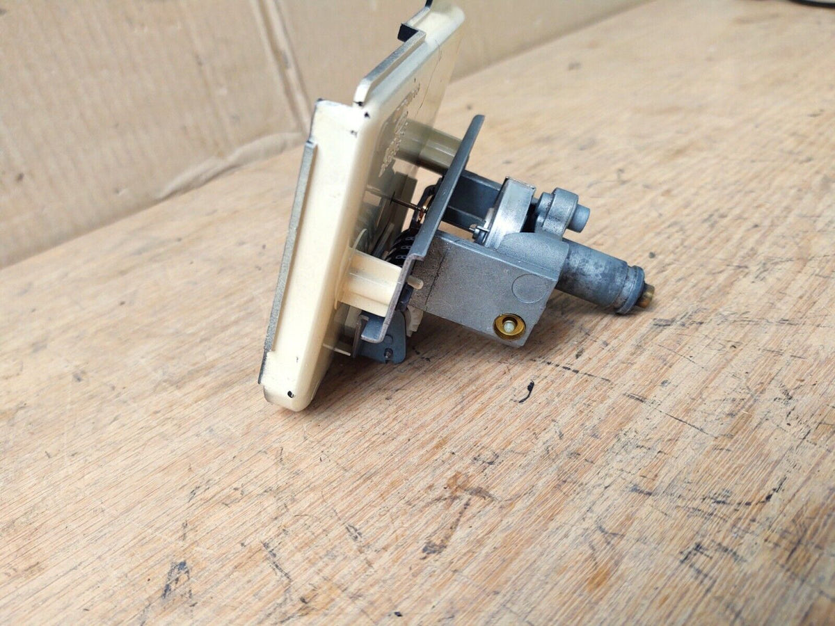 Side and rear view of an OEM Ford speedometer assembly (part E1TZ-17255-B) for 1980-1986 Ford F-150, F-250, F-350, and Bronco, showing the mechanical housing, mounting structure, and drive cable input.