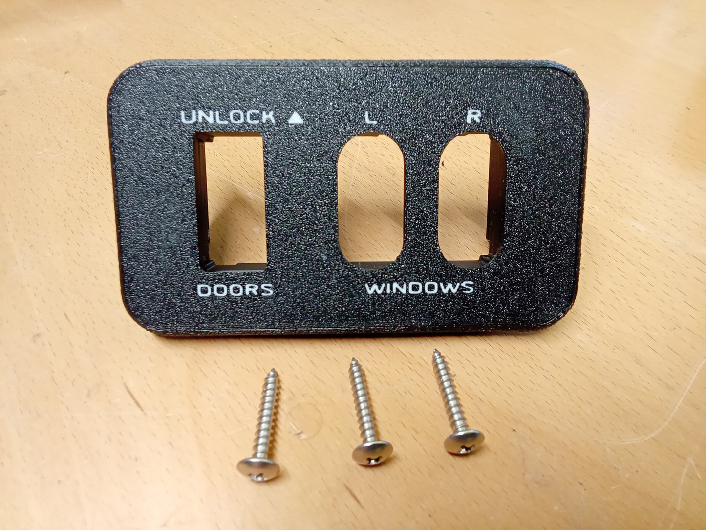 Ford power window and lock bezel for 1987-1991 F-150/F-350/Bronco, black with labels, includes three mounting screws.