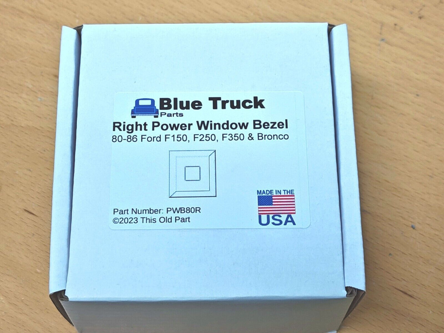 White product box for Blue Truck Parts Right Power Window Bezel, part number PWB80R, compatible with 1980-1986 Ford F-150, F-250, F-350, and Bronco models, showing a Made in the USA label.