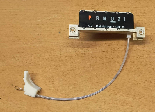 Refurbished Ford C6 automatic shift indicator for 1987-1991 F-Series trucks and Broncos, showing 'P R N D 2 1' and 'C6 Transmission - Code K' on a black display, attached to a clear cable and white plastic connector.
