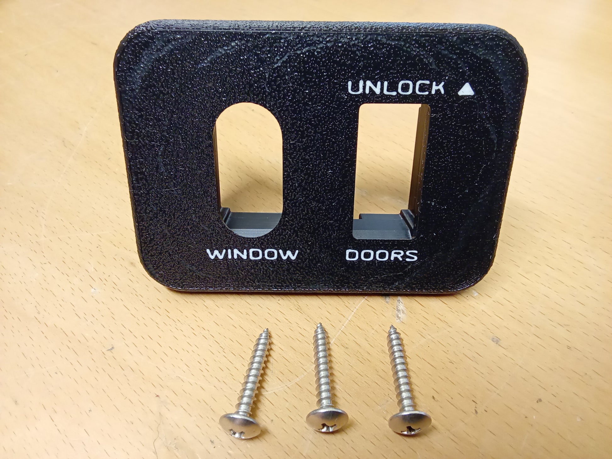 Ford power window and lock bezel for 87-91 F150/F250/F350/Bronco, with inlaid lettering, shown with mounting screws.