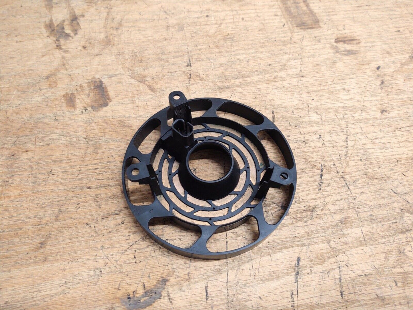 OEM Ford steering wheel clock spring for 1992-1997 F150, F250, F350, and Bronco models without airbags. Features a black circular plastic housing with internal concentric metal contact tracks.