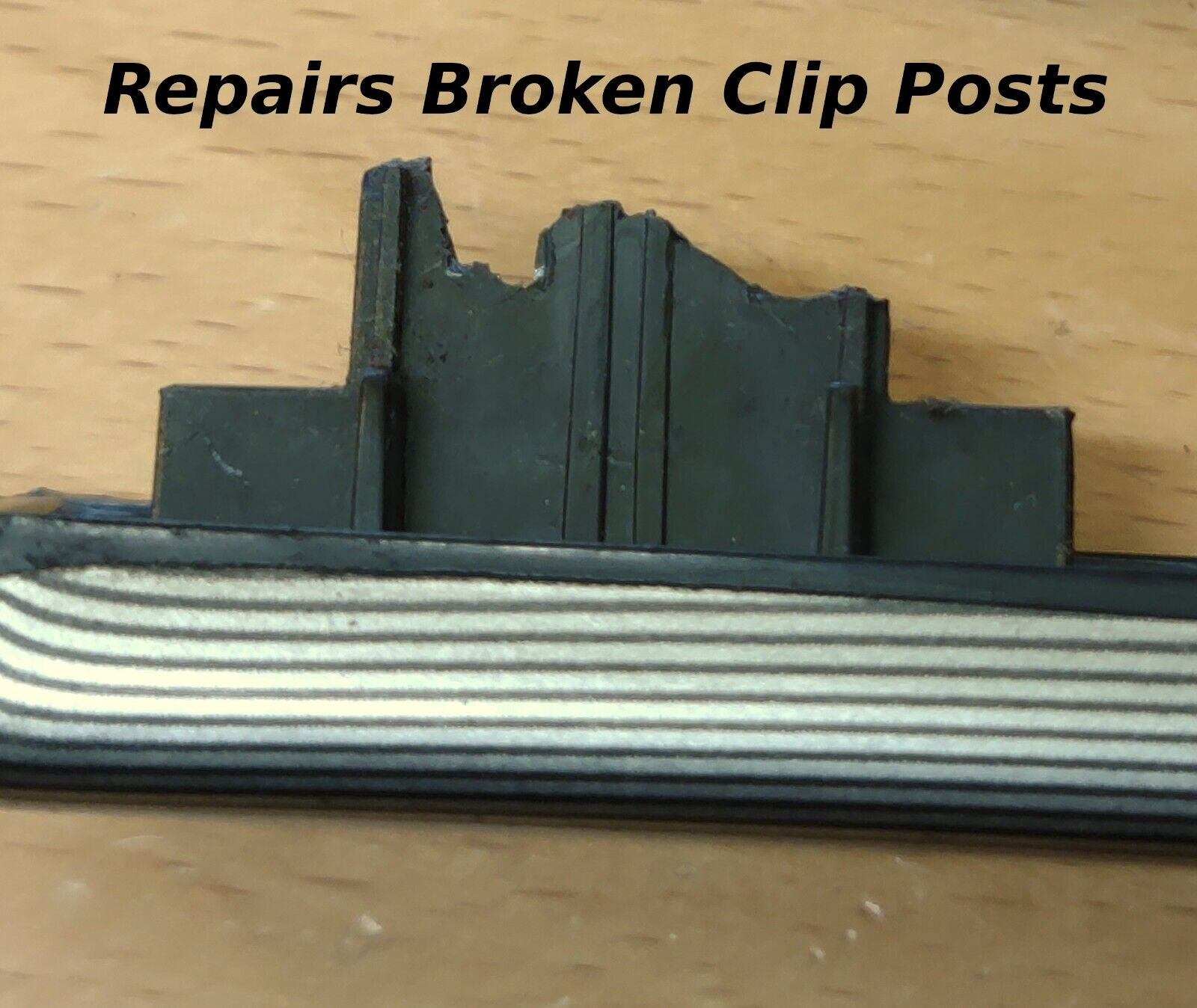 Close-up of a broken black plastic mounting post on the back of a Ford dash trim strip with text overlay stating Repairs Broken Clip Posts