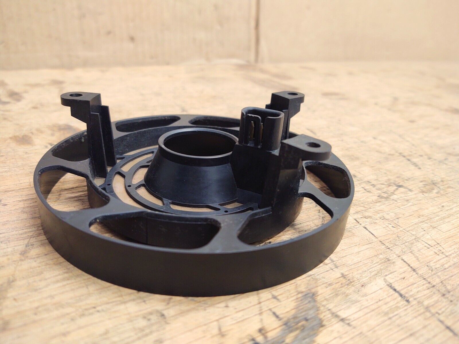 OEM Ford steering wheel clock spring or contact assembly for 1992-1997 Ford F-Series trucks and Bronco without airbag, showing the black plastic housing with mounting tabs and an electrical connector.
