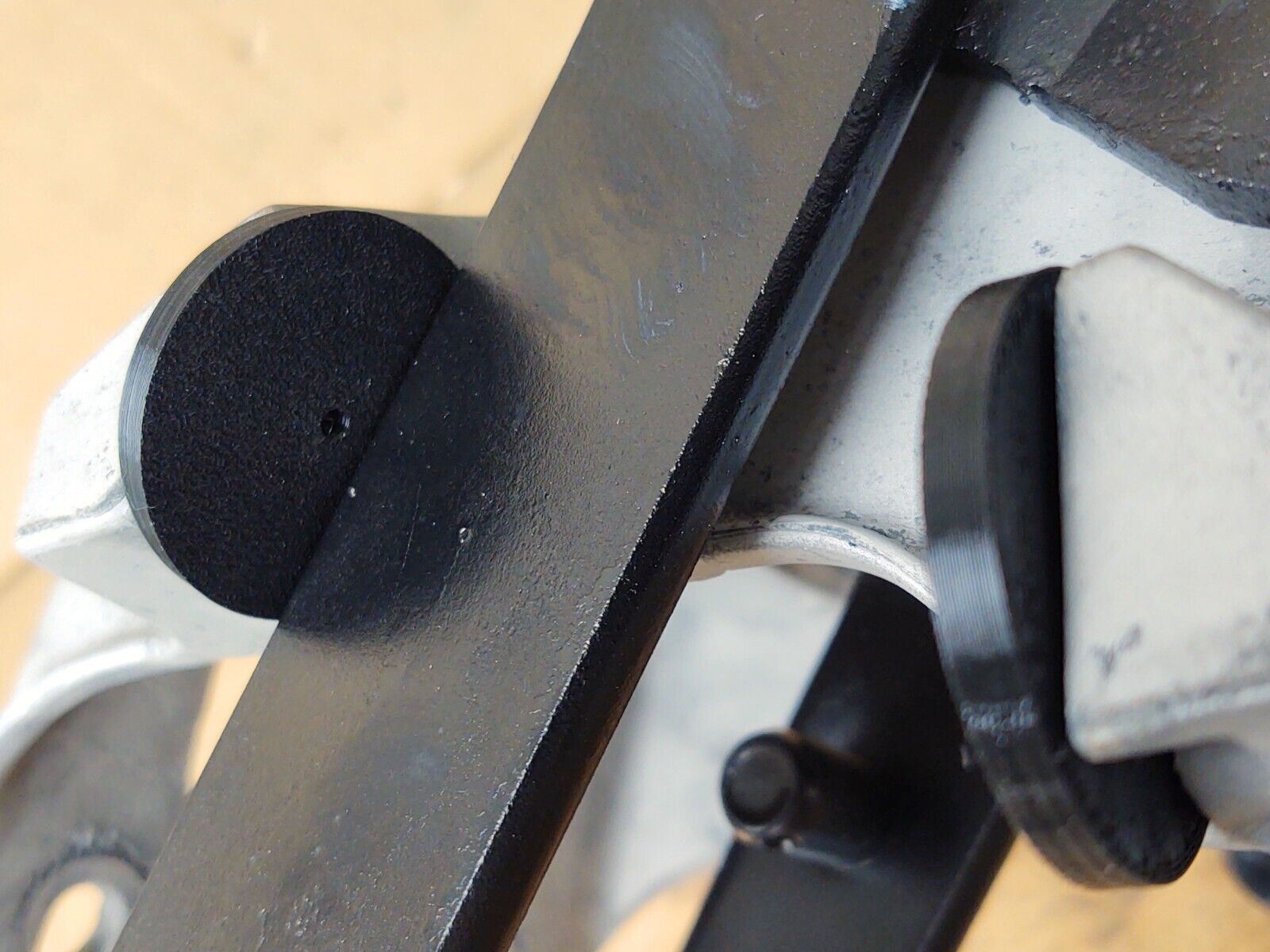 Two black rubber clutch pedal bumpers installed on a silver bracket and black metal pedal arm assembly, designed to limit pedal movement on 1980-1991 Ford trucks.