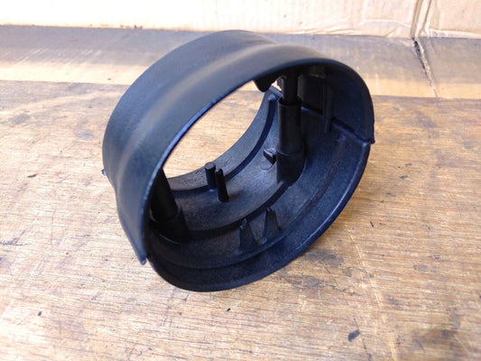 OEM black plastic tilt steering column bezel for 1987-1991 Ford F150, F250, F350, and Bronco, showing the assembled top and bottom shroud pieces with interior mounting pegs.