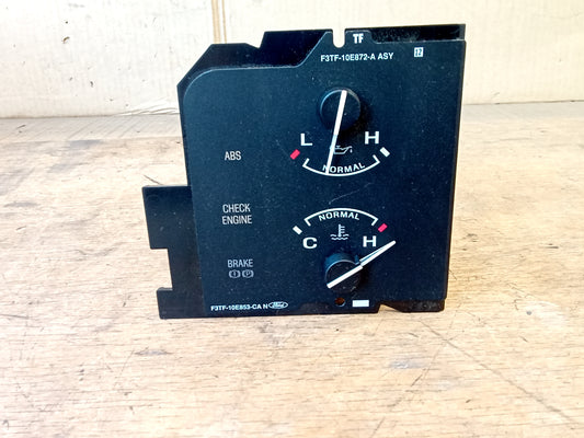 OEM Ford oil pressure and temperature gauge cluster for 1992-1993 Bronco and F-Series trucks. Features dual gauges (L-H and C-H) with warning lights for ABS, Check Engine, and Brake.