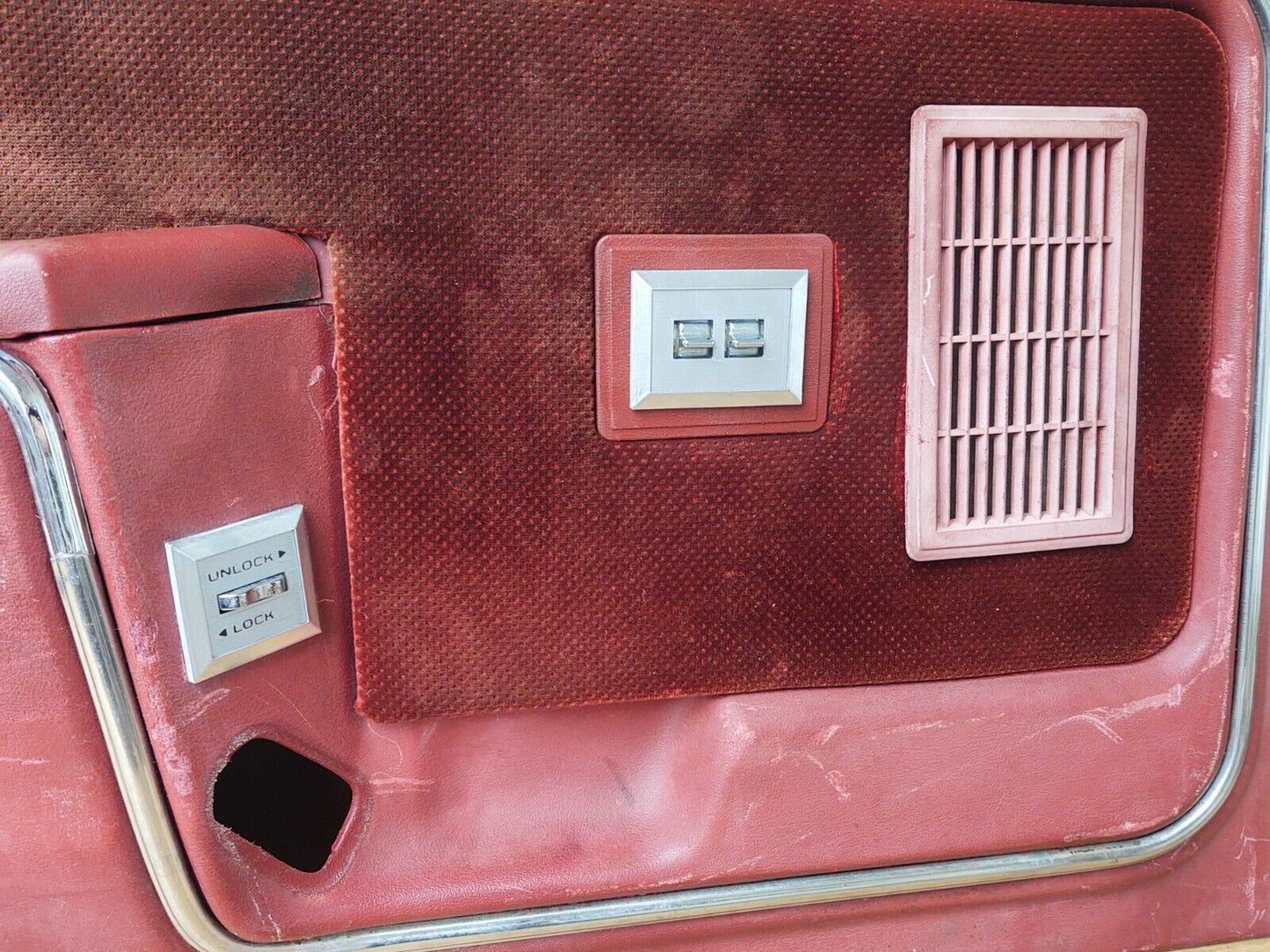 Left power window bezel installed on a 1980-1986 Ford truck or Bronco driver's side door panel, holding a silver dual window switch.