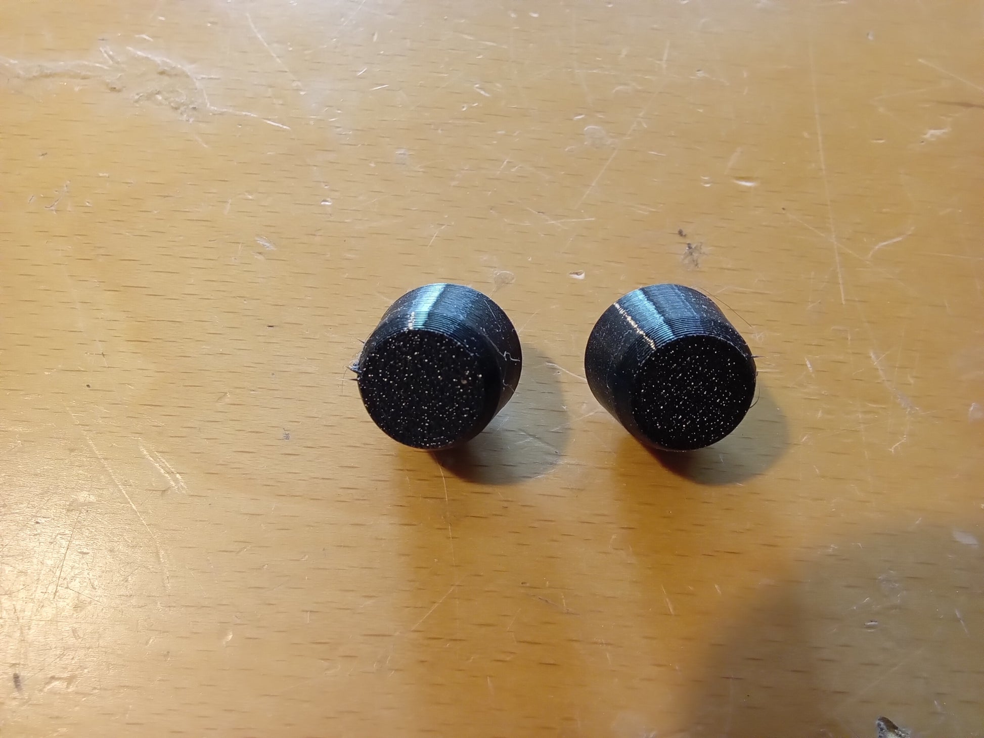 Pair of black rubber lid bumpers for center console, compatible with 1992-1997 Ford F-series and Bronco models.