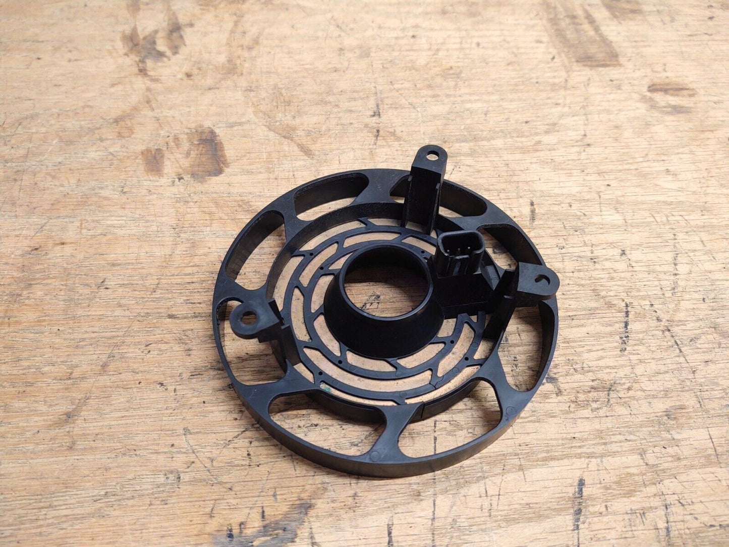 OEM Ford steering wheel clock spring for 1992-1996 Ford trucks without airbags. The circular black plastic component features internal copper contact traces, mounting tabs, and a black electrical connector port.