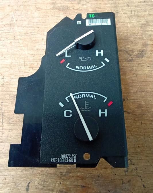 OEM Ford oil pressure and temperature gauge module for 1992-1997 Ford F-Series trucks and Bronco. Features black faceplate with two analog gauges and part number F2TF 10E853-GD N printed at the bottom.