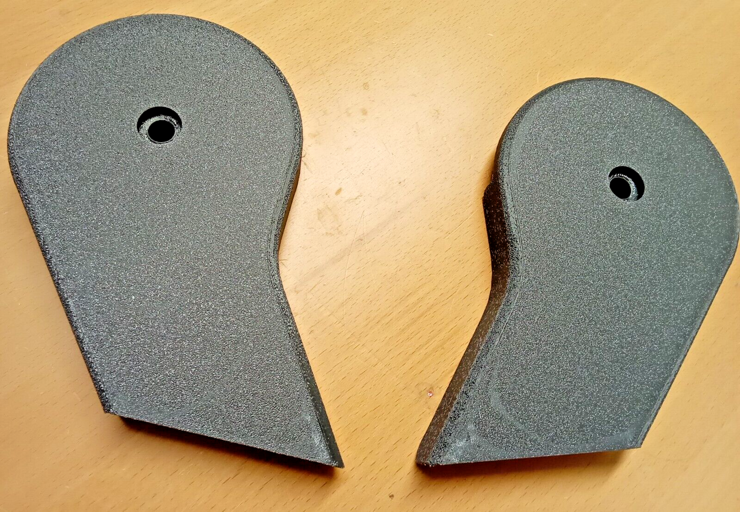 Pair of dark granite gray textured seat hinge covers with a single mounting hole, designed for 1992-1997 Ford F150, F250, and F350 trucks.