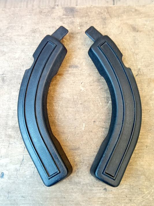 Black bench seat hinge covers for Ford 1980-1986 F-Series trucks and Bronco, featuring a metal clip design.