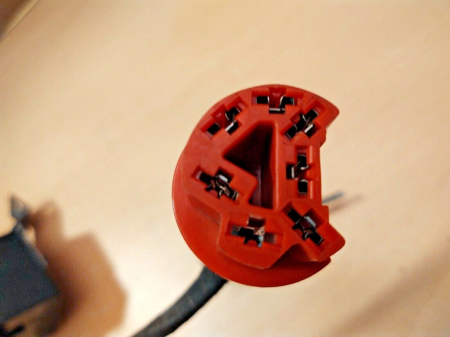 Red electrical connector plug with internal metal terminals, part of a Ford intermittent delay wiper switch module E7TF-17C476 for 1980-1991 F150, F250, F350, and Bronco.