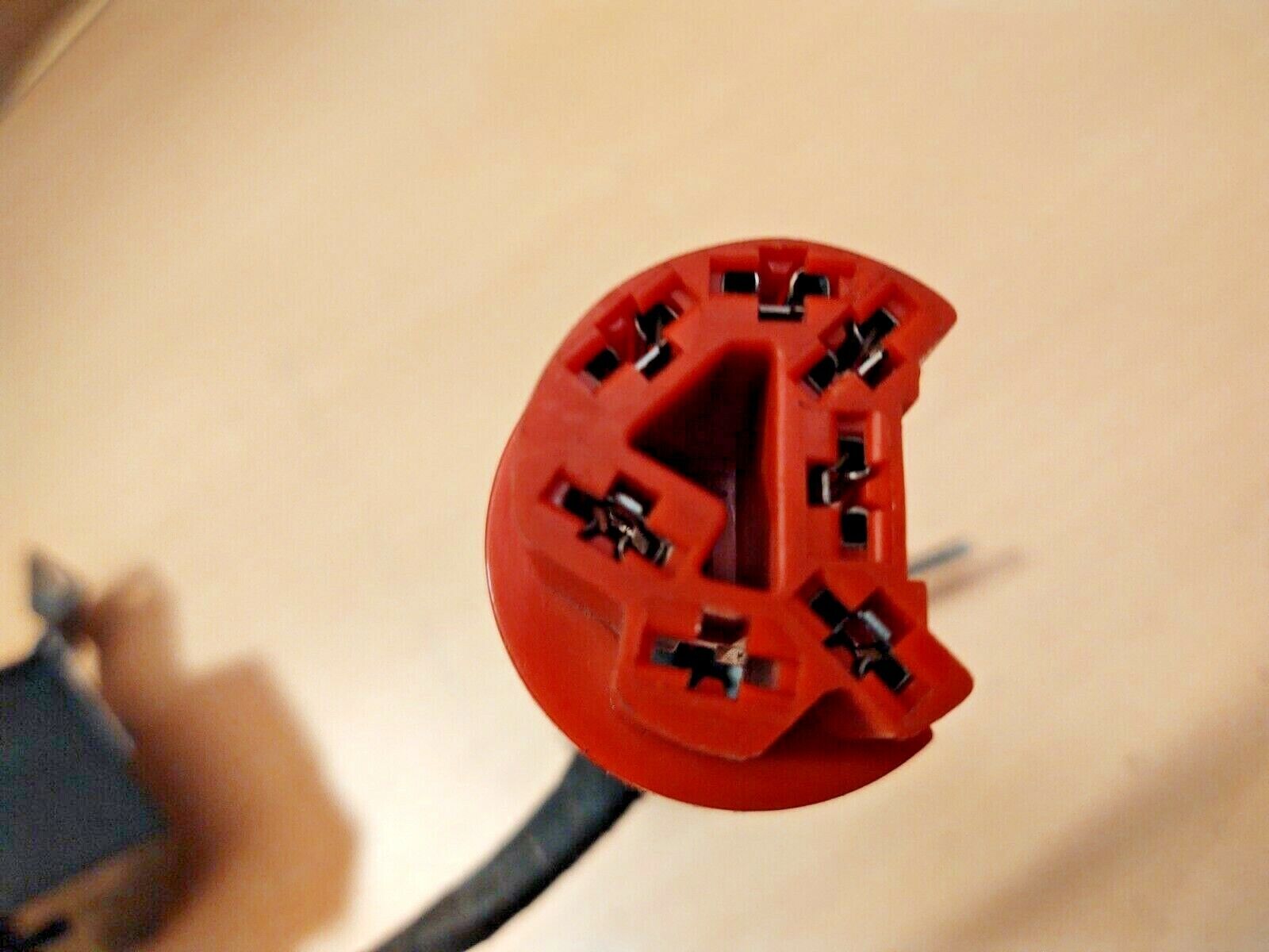 Red electrical connector plug with internal metal terminals, part of a Ford intermittent delay wiper switch module E7TF-17C476 for 1980-1991 F150, F250, F350, and Bronco.